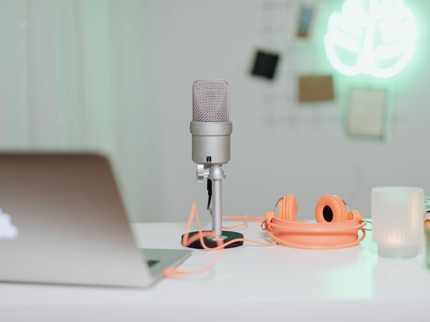 A microphone and headphones on a studio desk
