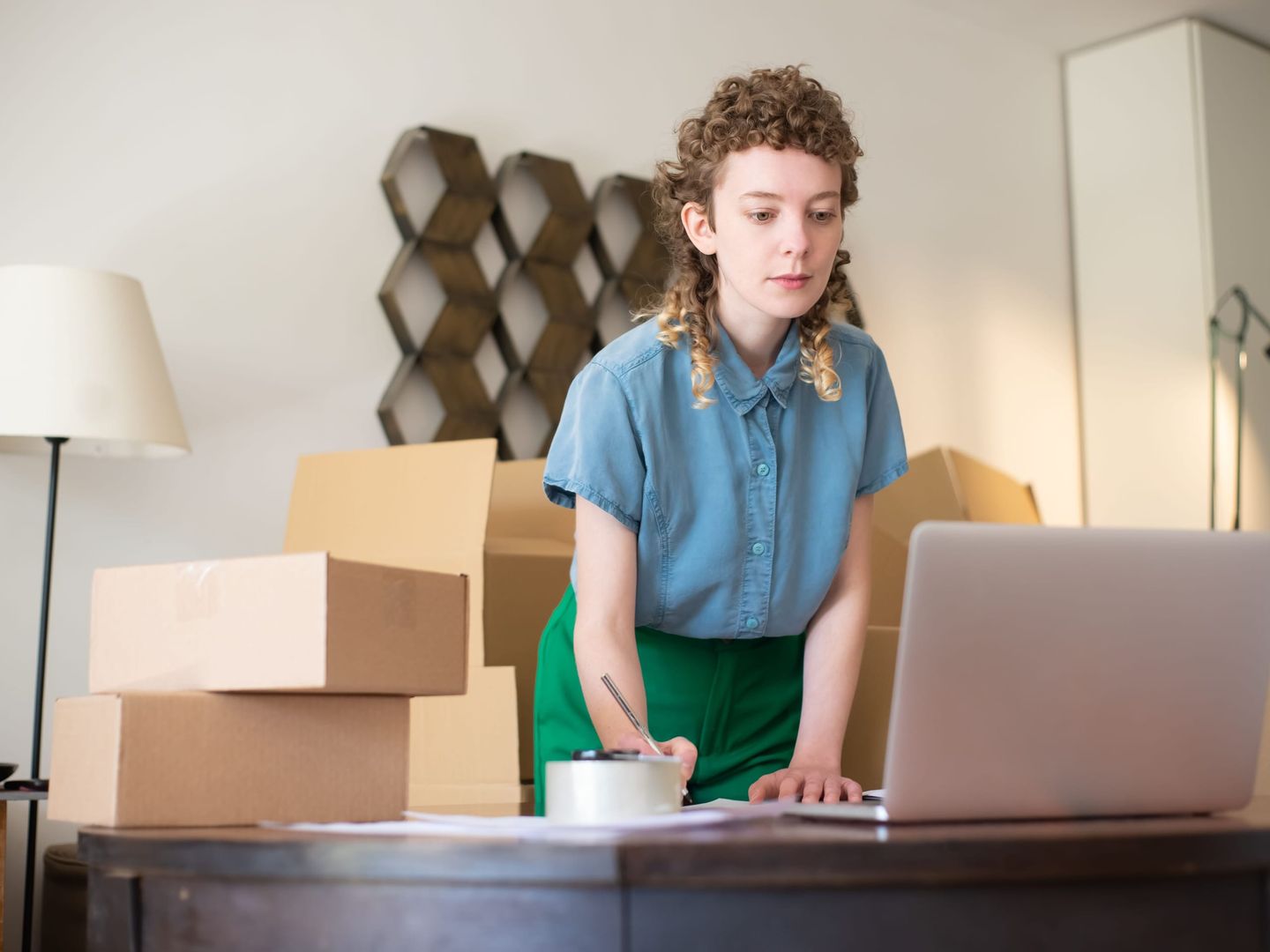 A founder at a laptop with the first invoices beside it