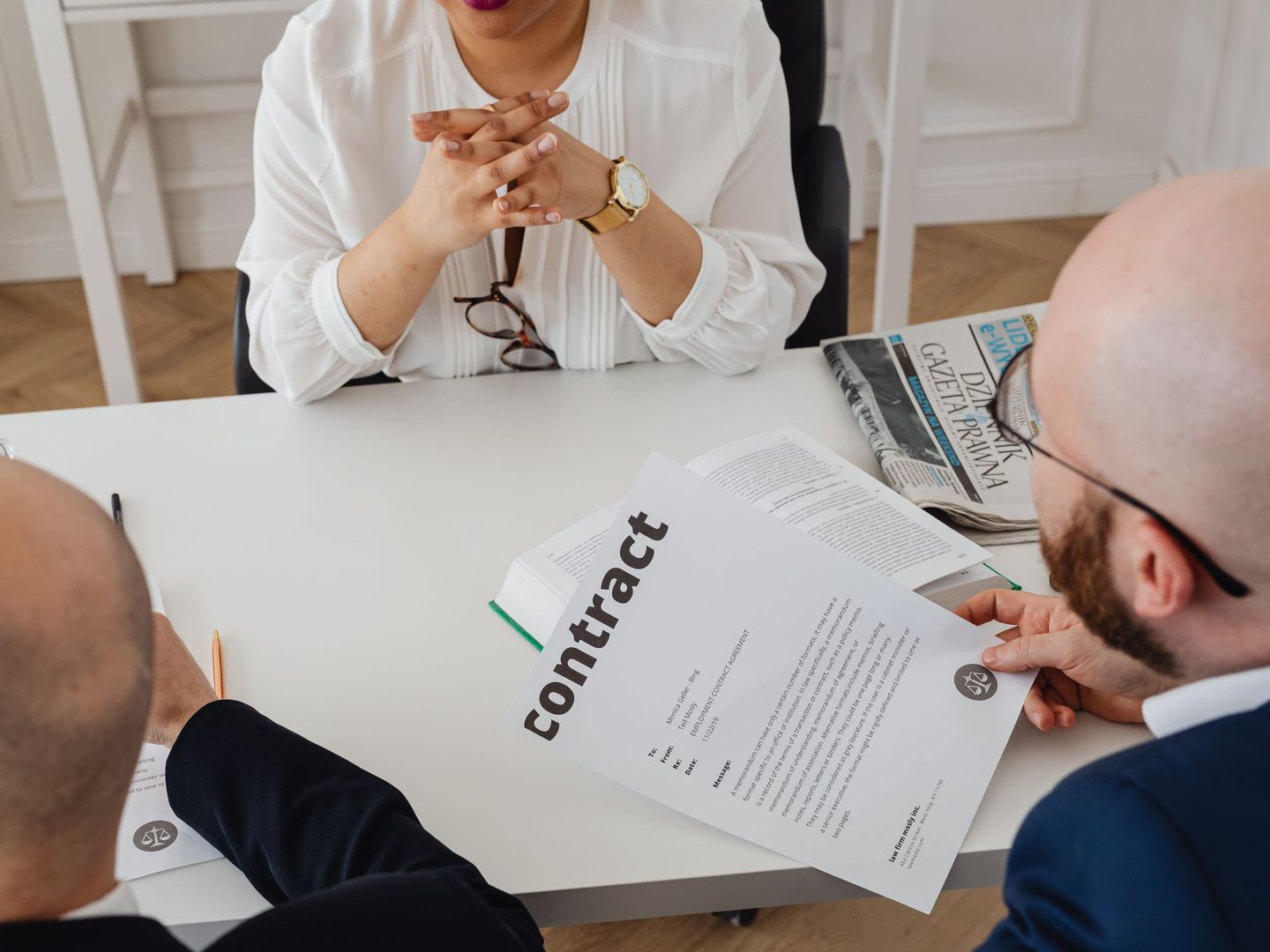 A contract being reviewed across a table
