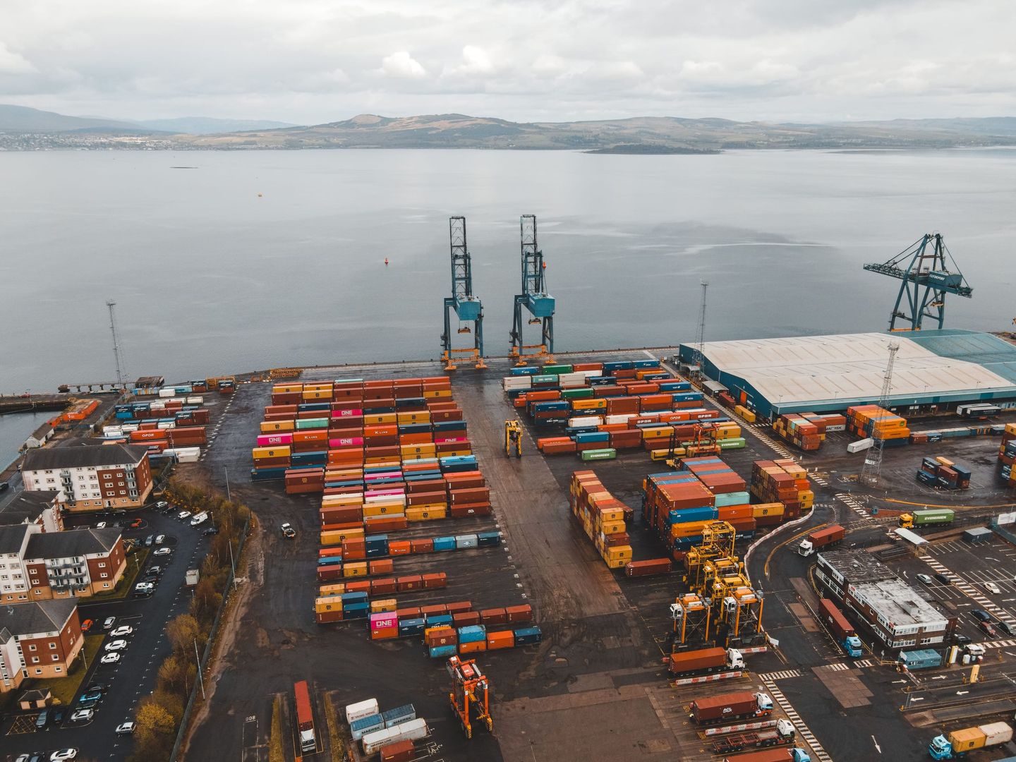 A manager at a port checking shipments on a tablet