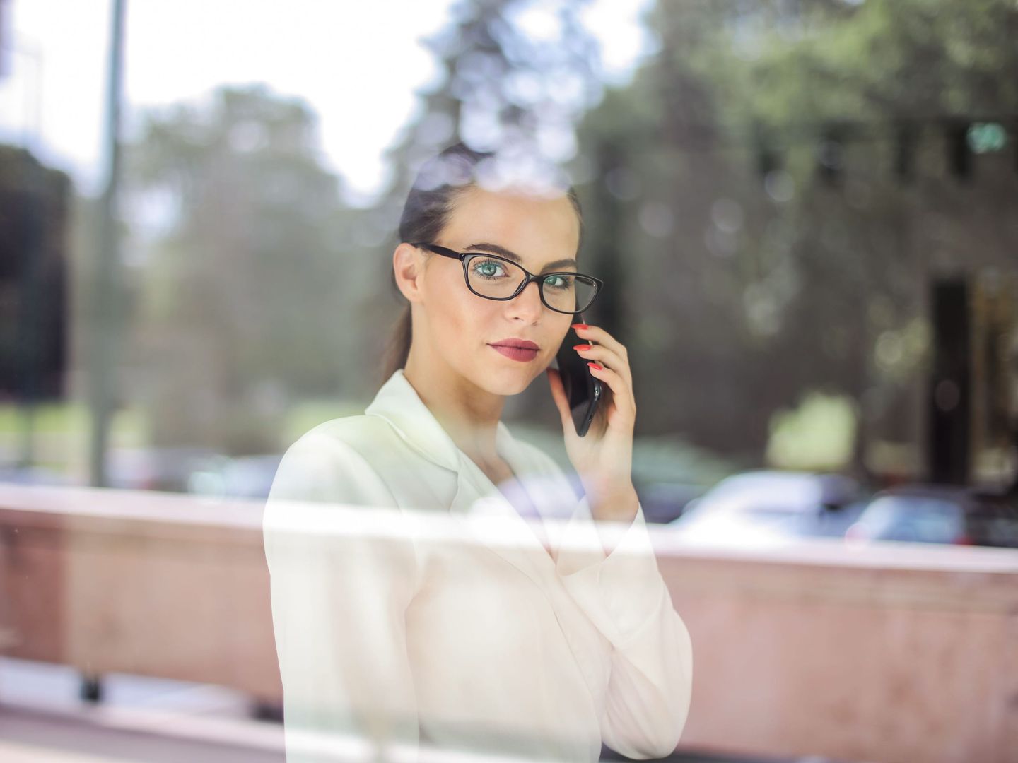 A founder on a call at an office window