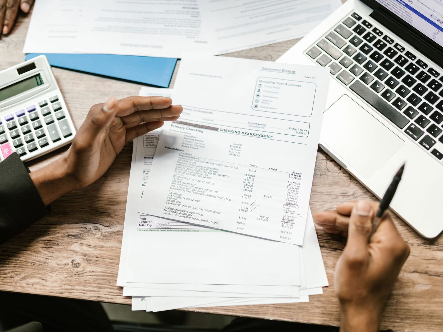 An auditor and an owner reviewing accounts